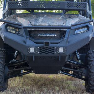The front end of a utv in a grassy field.