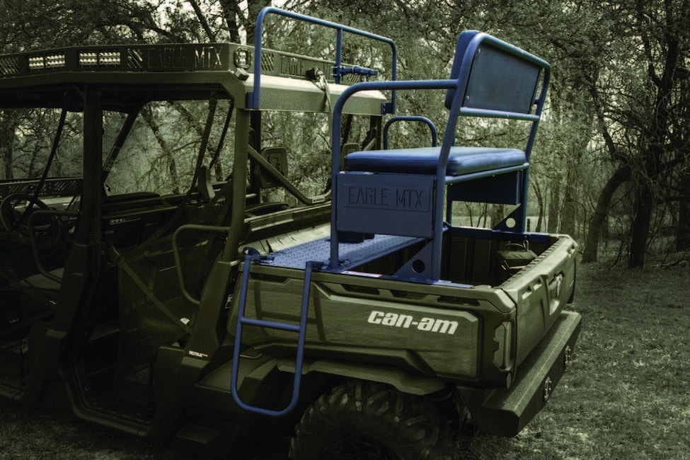 A blue utv with a seat in the woods.